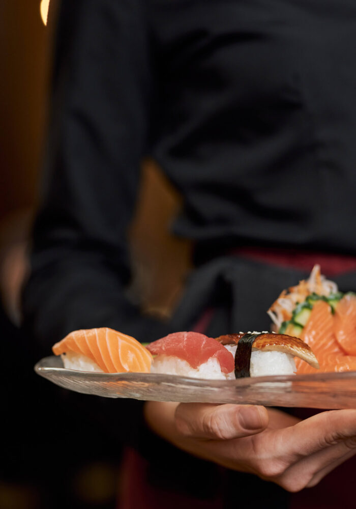 appetizing-sushi-plate-hands-restaurant-staff (1)