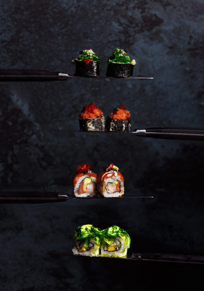 gourmet-sushi-rolls-artfully-presented-dark-shelves gourmet-sushi-rolls-artfully-presented-dark-shelves