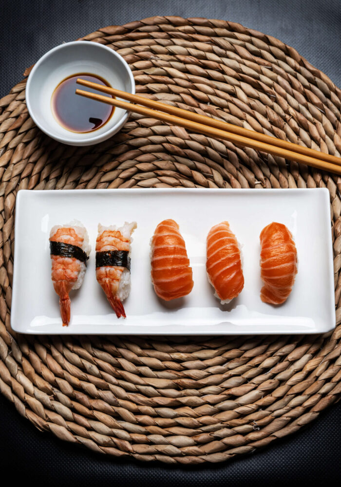 nigiri-sushi-white-ceramic-plate-with-chopsticks-bowl-with-soy-sauce-round-wicker-tablecloth-black-background nigiri-sushi-white-ceramic-plate-with-chopsticks-bowl-with-soy-sauce-round-wicker-tablecloth-black-background